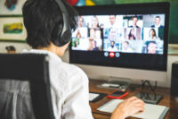 Woman working at home having a video conference with colleagues